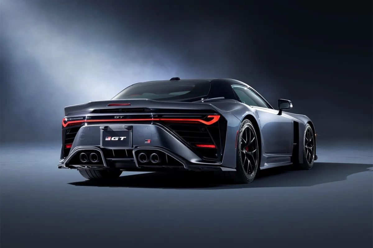 Rear three quarter view of the Toyota GR GT in a studio setting, showing its quad exhausts, wide stance and full width tail light.