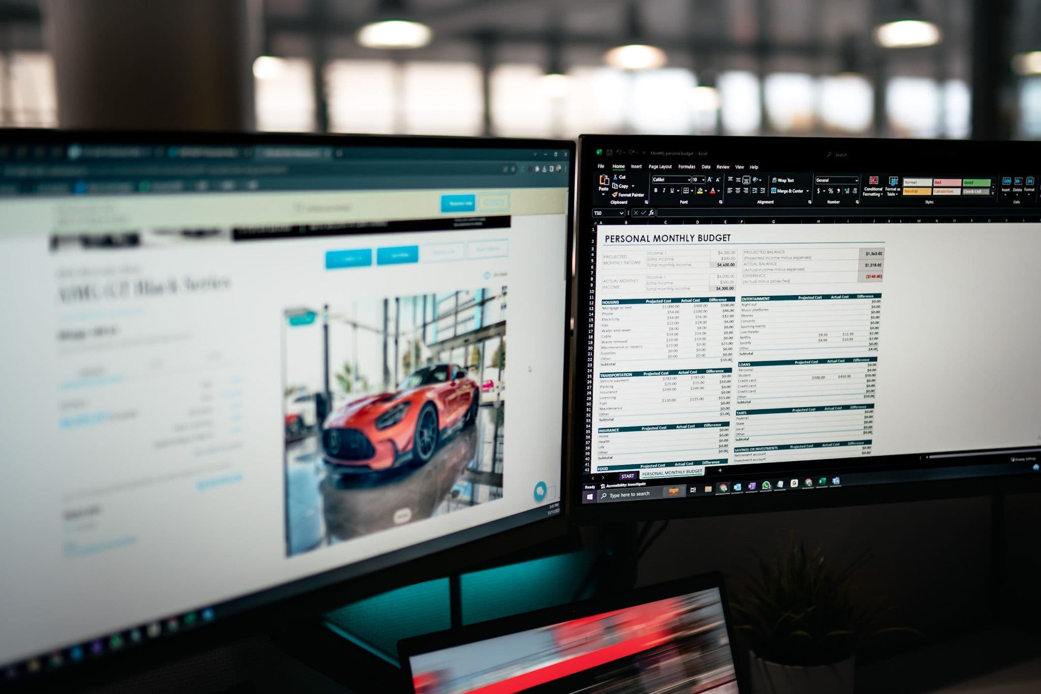 Dual computer monitors showing a car listing for a Mercedes-AMG GT and a personal monthly budget spreadsheet.