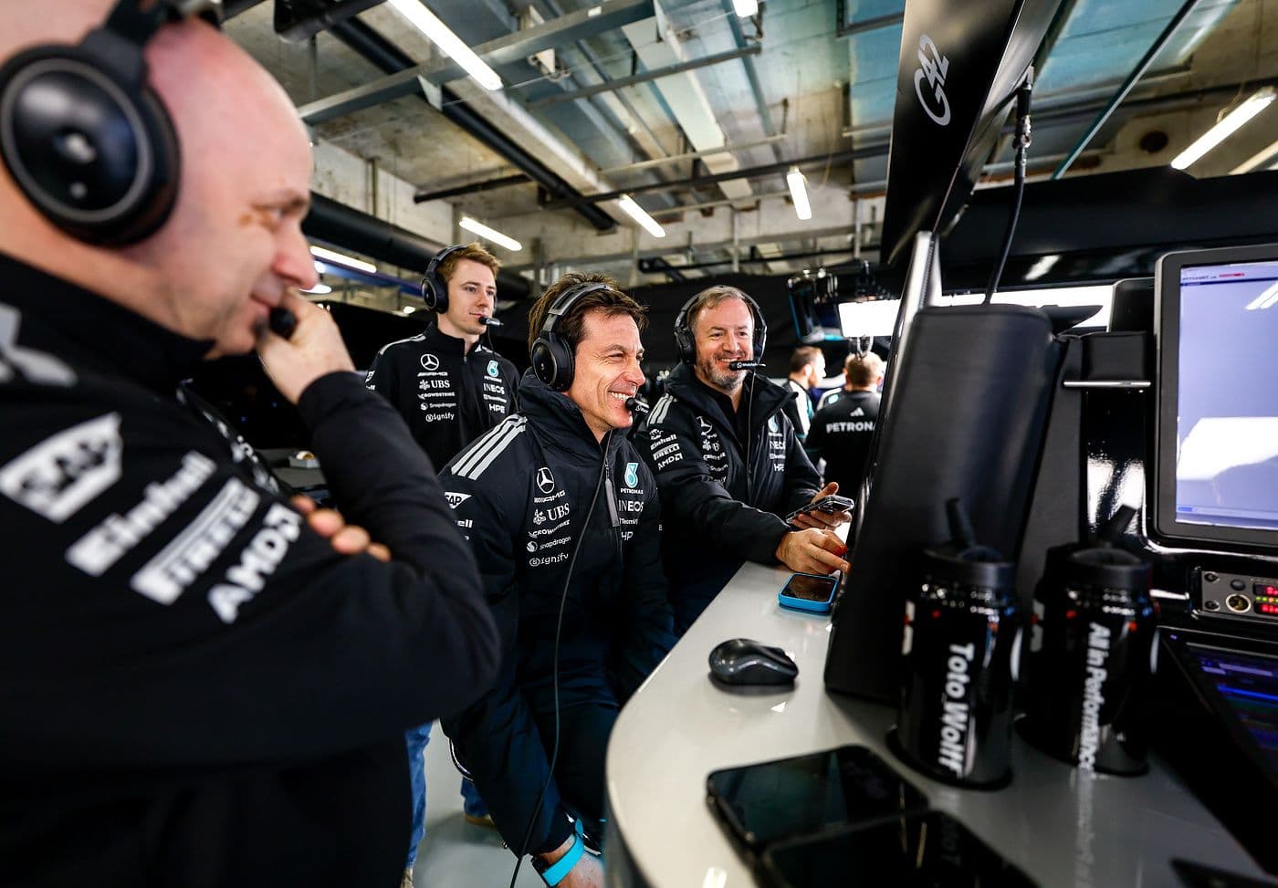 Mercedes-AMG Petronas Formula 1 team personnel monitoring timing screens from the pit garage wall during the 2026 Chinese Grand Prix at Shanghai International Circuit