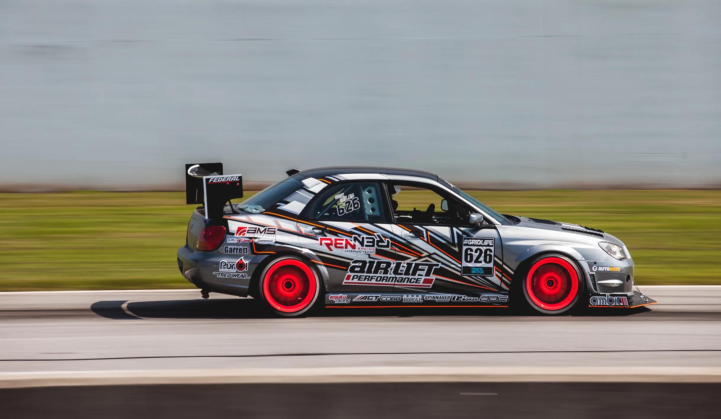 Subaru Impreza Hawkeye track car with Air Lift Performance suspension racing on track
