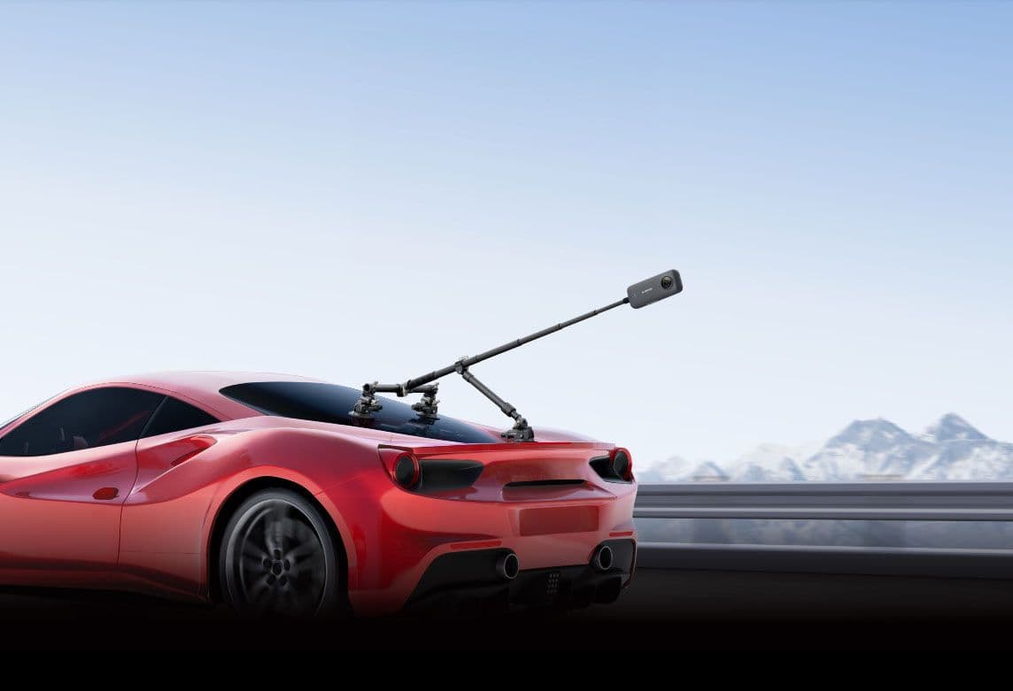 Insta360 X3 camera mounted on rear of a red Ferrari 488 driving on mountain road