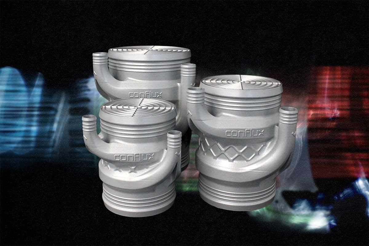 Conflux 3D printed barrel intercooler range in three sizes, with blurred blue and red charge air flow lines behind the additively manufactured cores