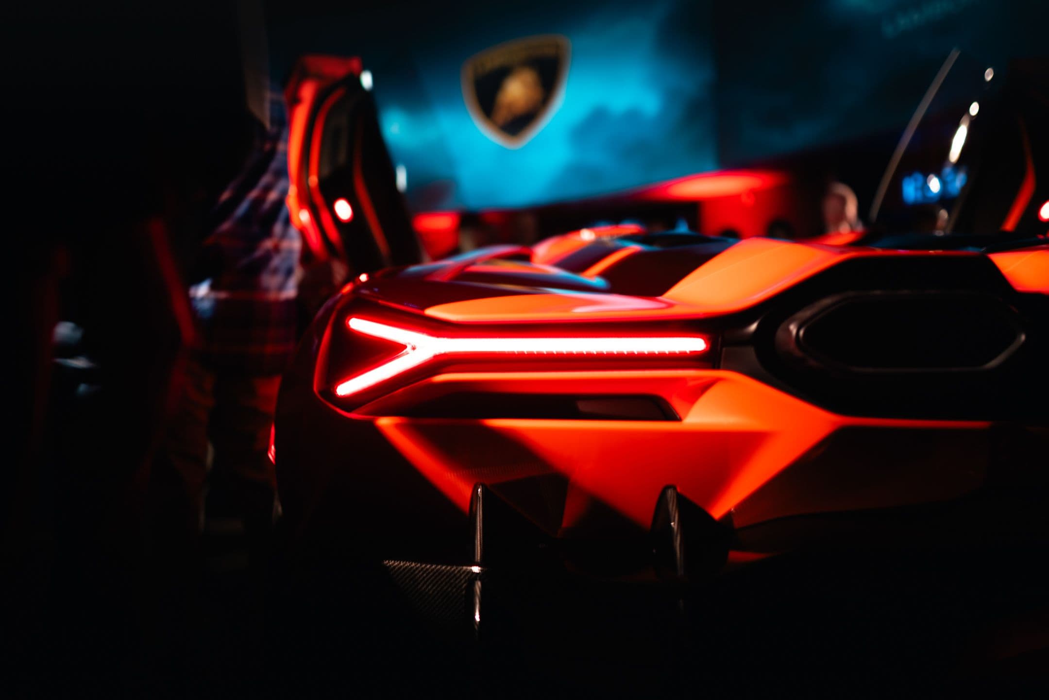 Rear LED light design of Lamborghini Revuelto with glowing Y-shaped tail lights at launch event.
