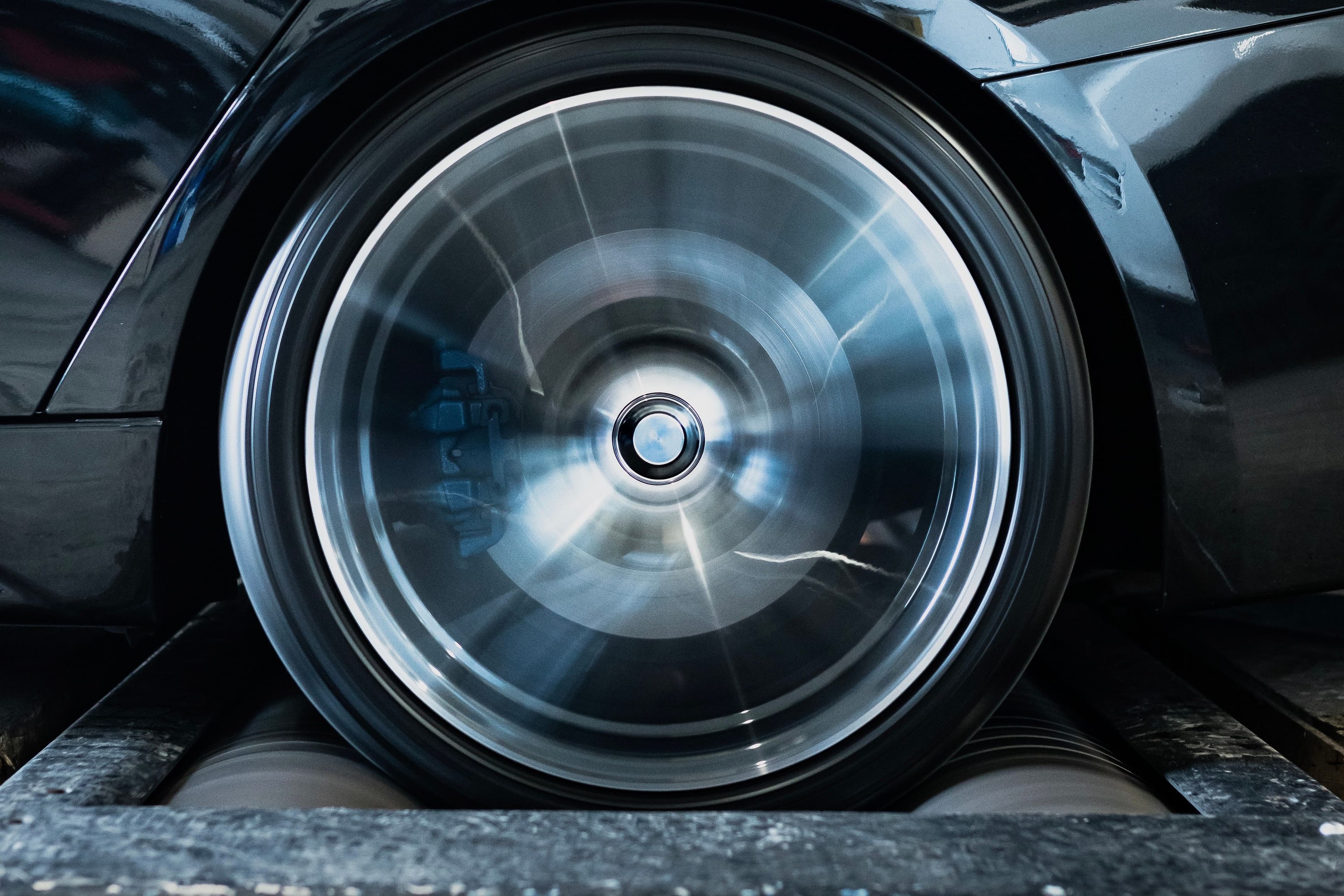 BMW F30 3 Series on a dyno at JBM Performance receiving custom ECU tuning for increased horsepower.