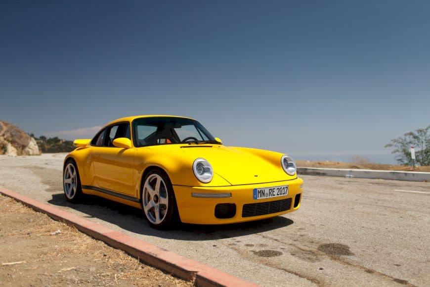 Yellow RUF CTR Anniversary parked on canyon roadside, blending 911 heritage with modern lightweight performance.