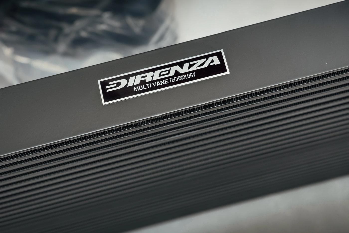 Close-up detail of Direnza Multi Vane Technology branding on intercooler core, showcasing internal vane design for optimised air distribution.