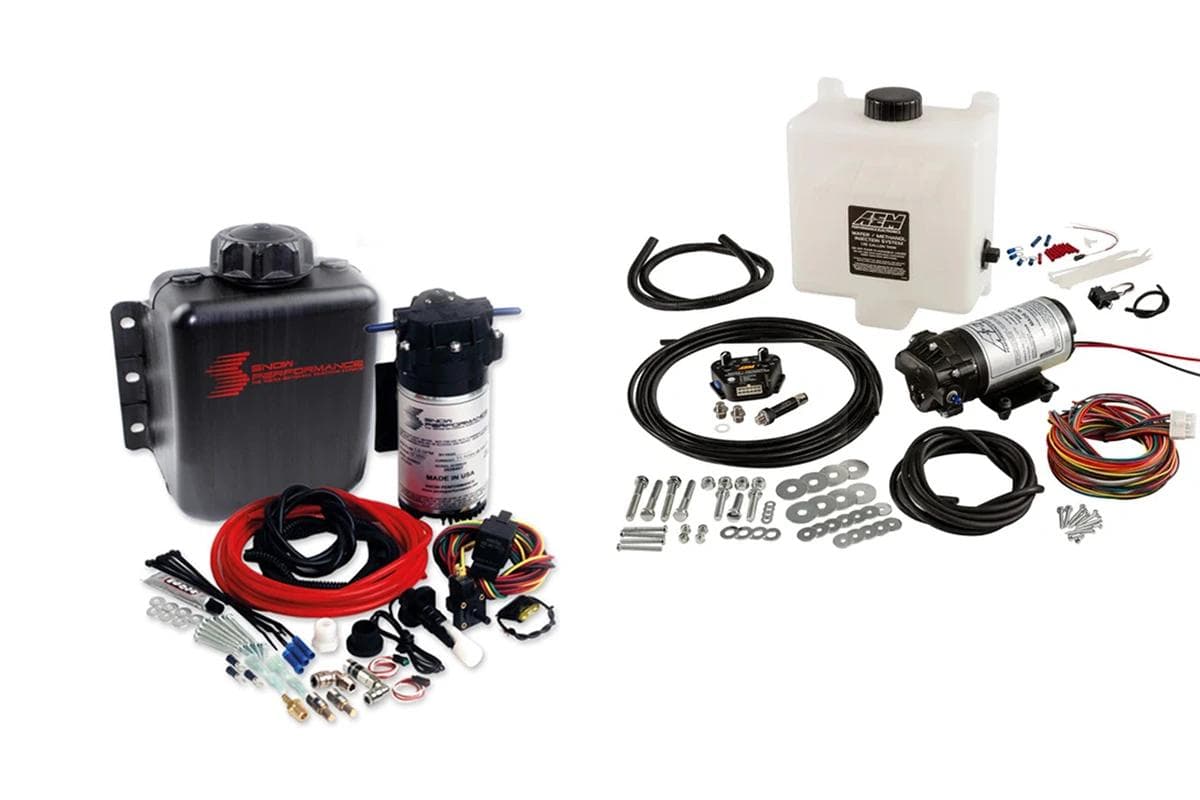 Snow Performance and AEM water methanol injection kits laid out with reservoirs, pumps, hoses, wiring looms, and injector fittings for turbocharged engines.