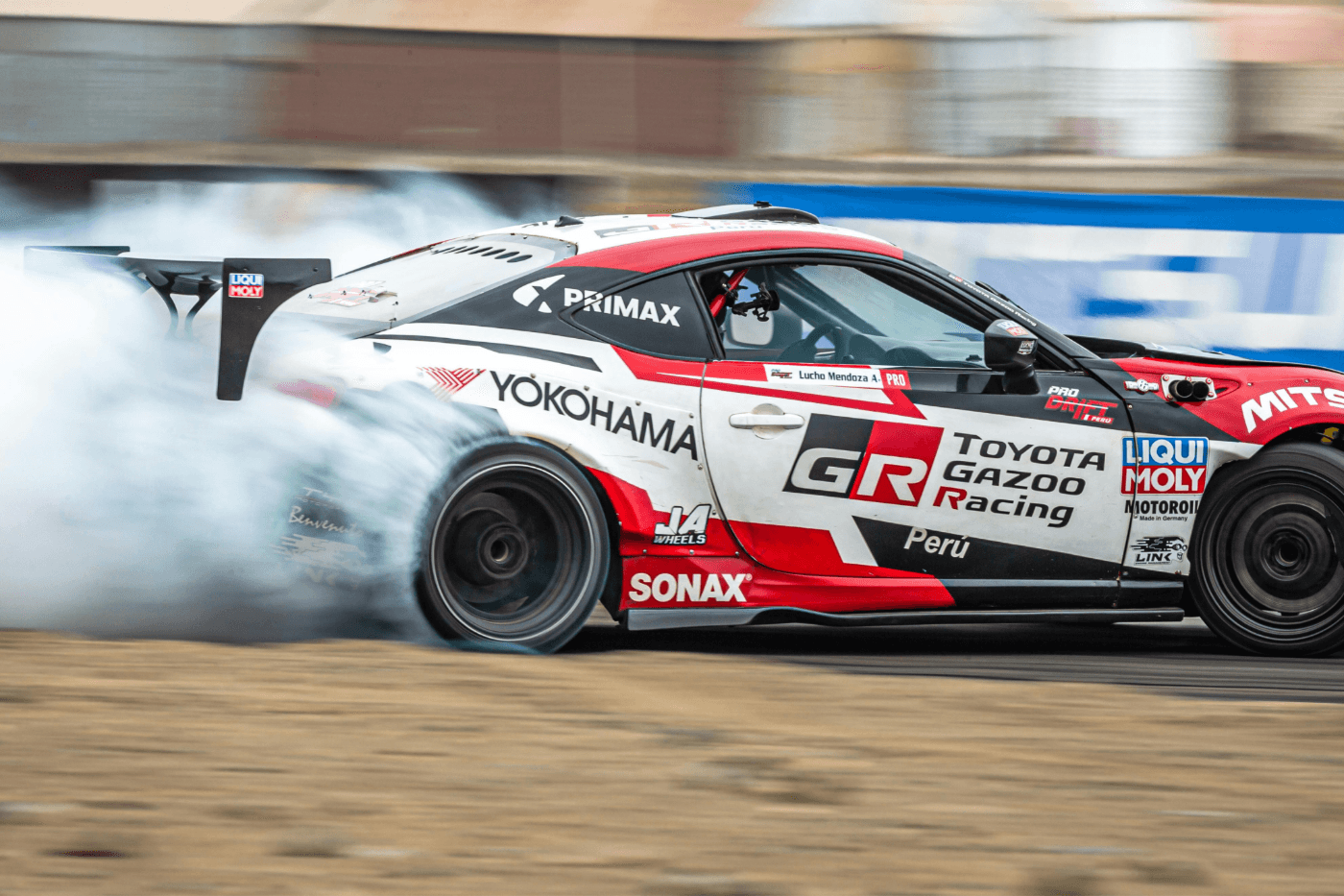 Toyota GT86 drift car from Toyota Gazoo Racing Peru creating tyre smoke during a high-speed drift event