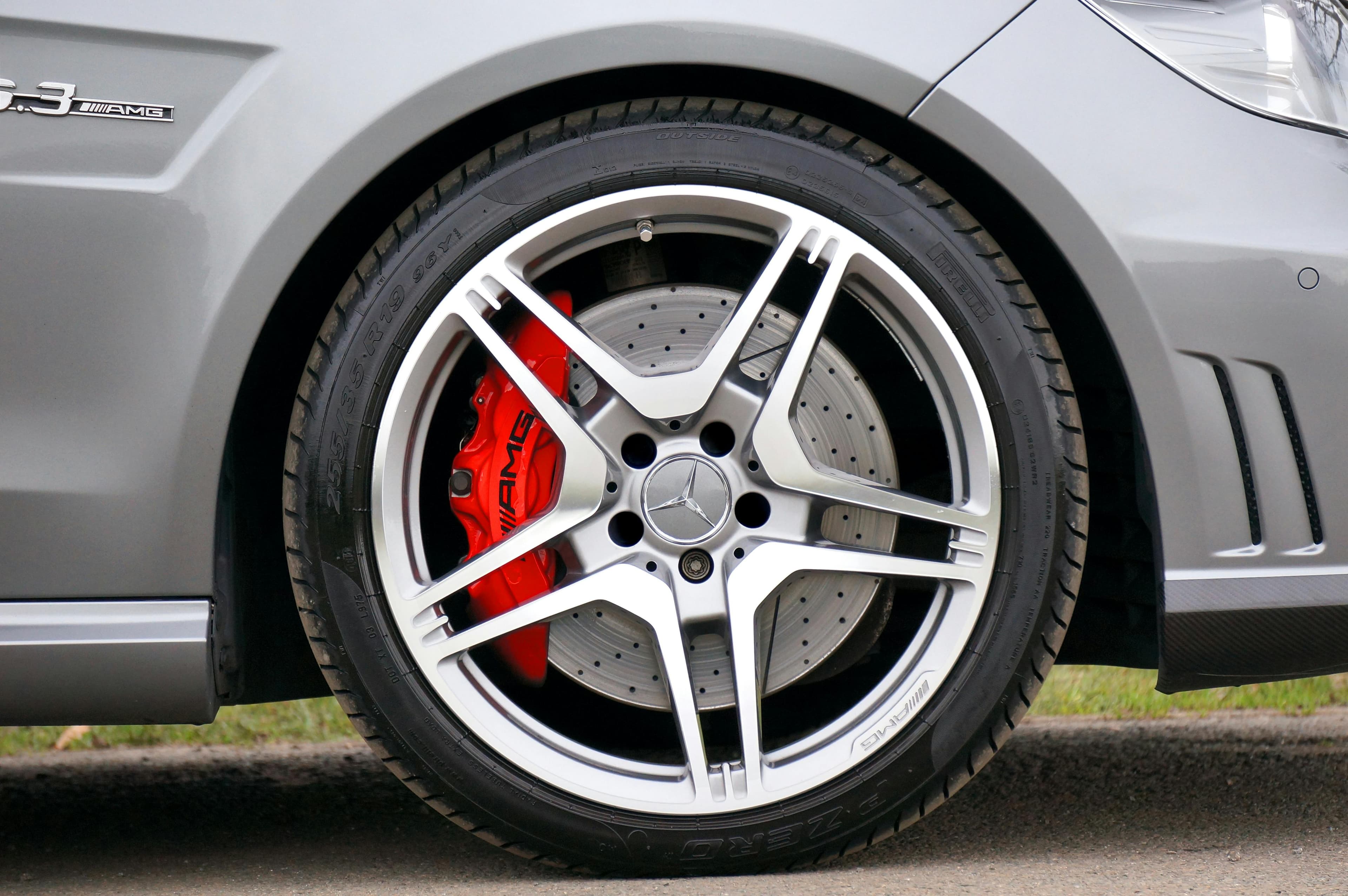 Mercedes-Benz C63 AMG W204 wheel with high-performance tyres and red AMG brake calipers