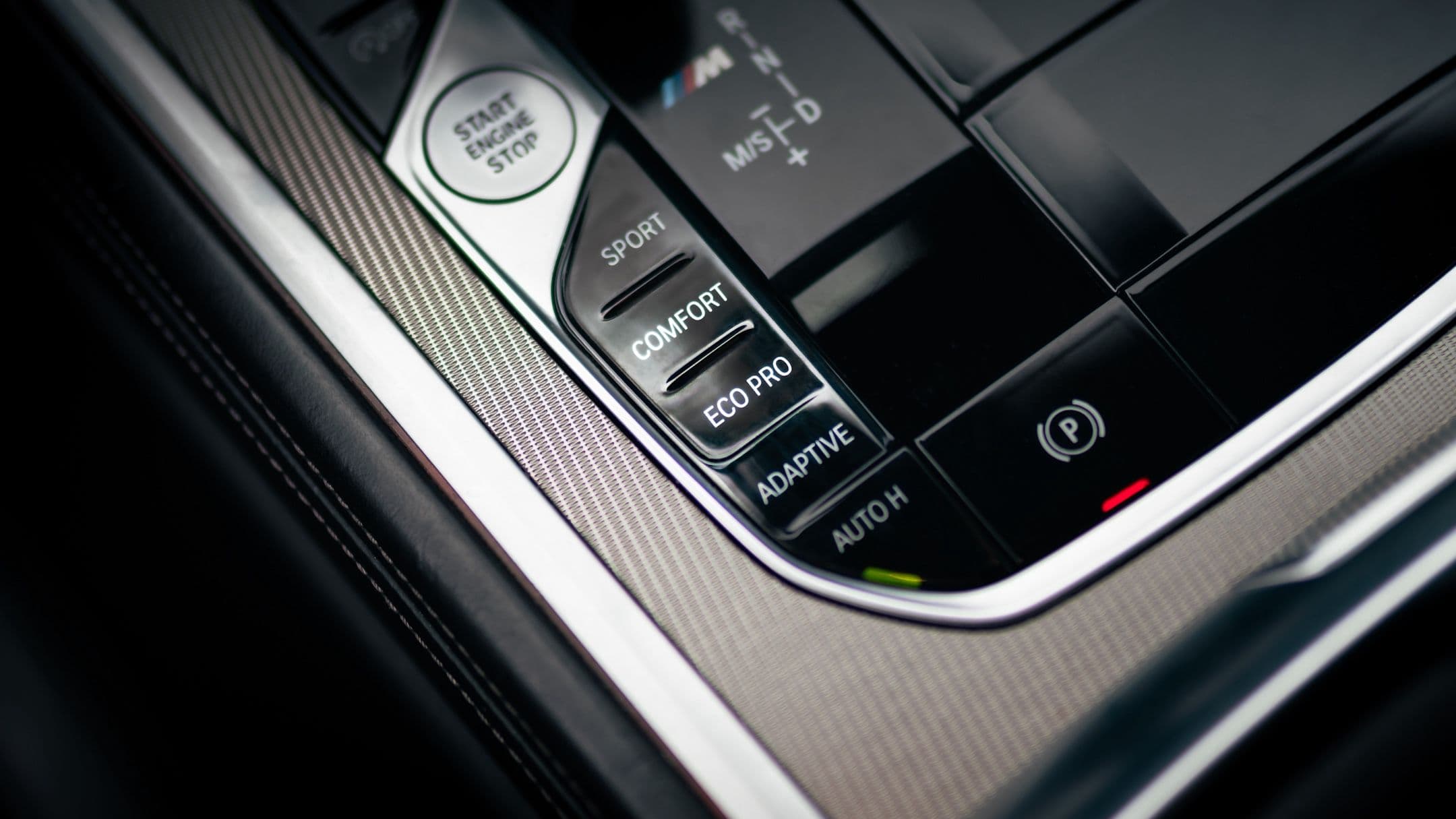 BMW drive mode selector with Eco Pro, Comfort, and Sport settings in a modern vehicle interior
