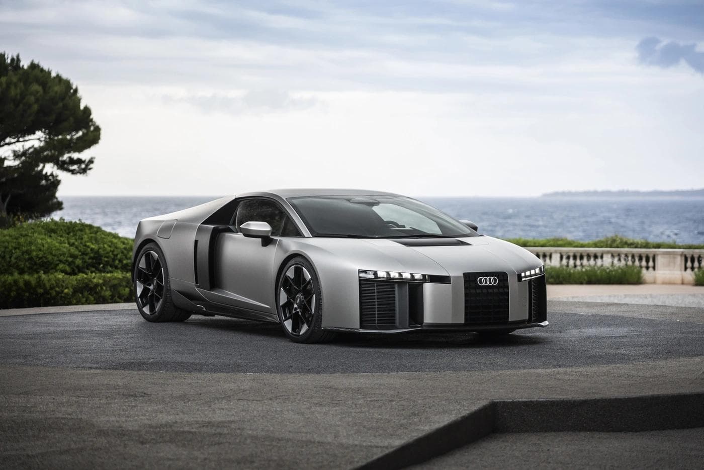 Front three-quarter view of the Audi Nuvolari, the 987hp R8 successor, finished in Titanium matte at its Monaco Grand Prix reveal in June 2026.