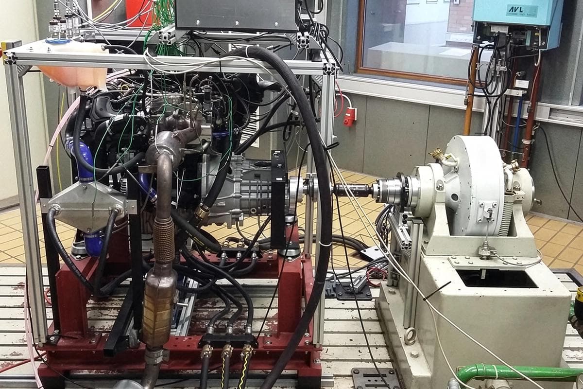 Engine mounted on a test stand connected to a dyno at Heilbronn University during controlled power testing.
