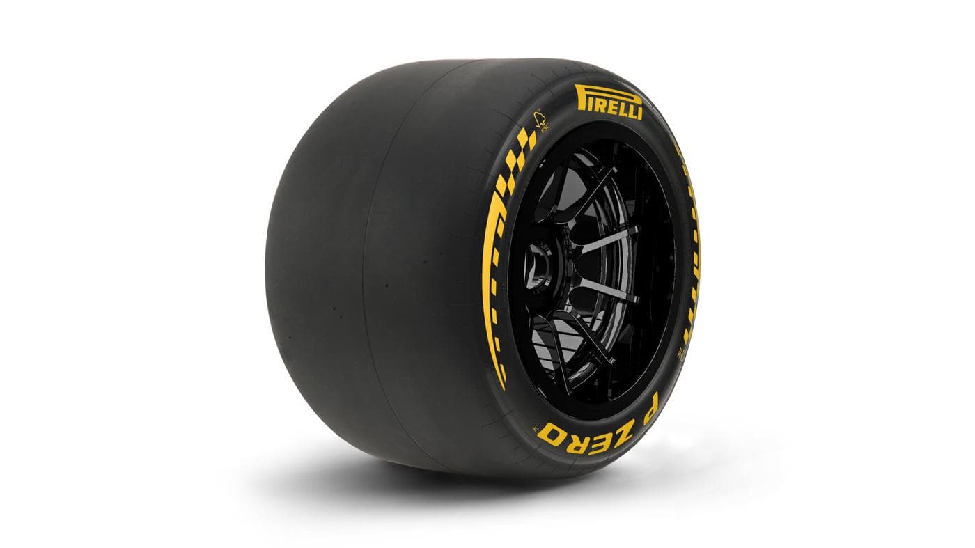 Pirelli P Zero medium compound Formula 1 rear tyre on a black multi-spoke wheel, yellow sidewall lettering visible against a white studio background
