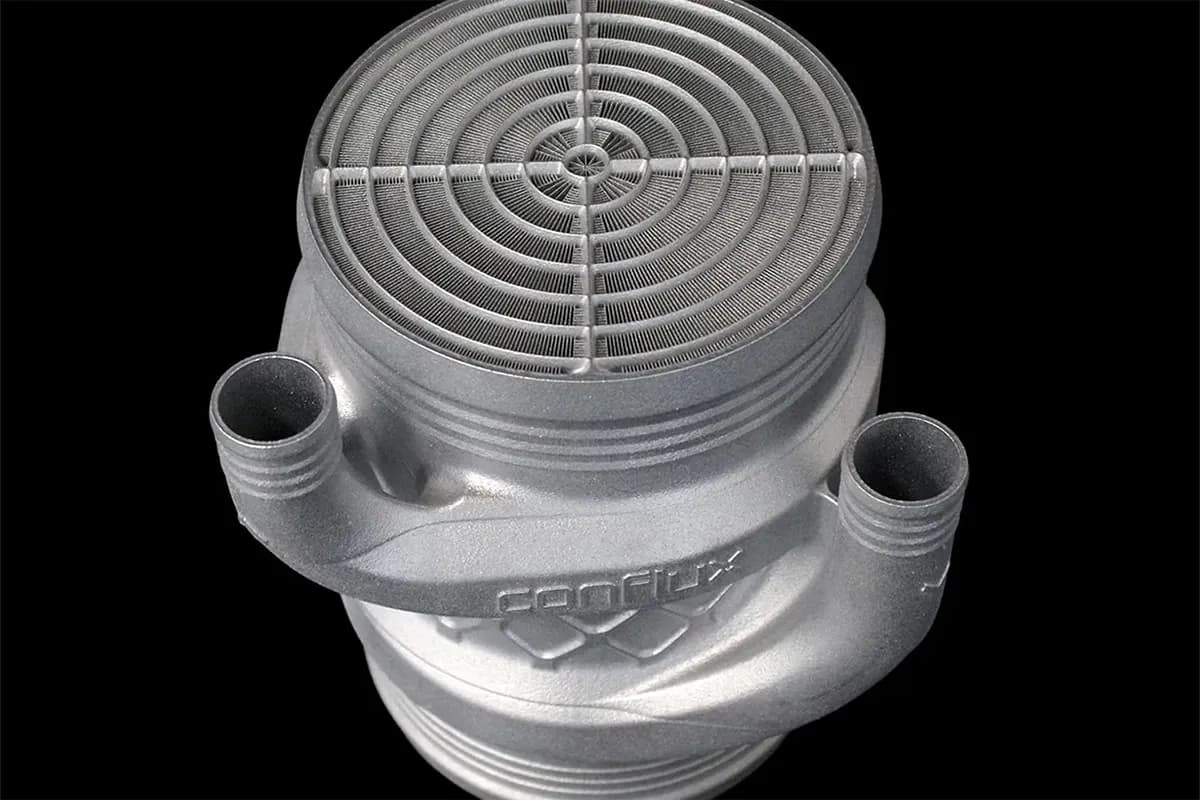 Top view of a Conflux barrel intercooler showing the radial printed fin pattern of the additively manufactured core