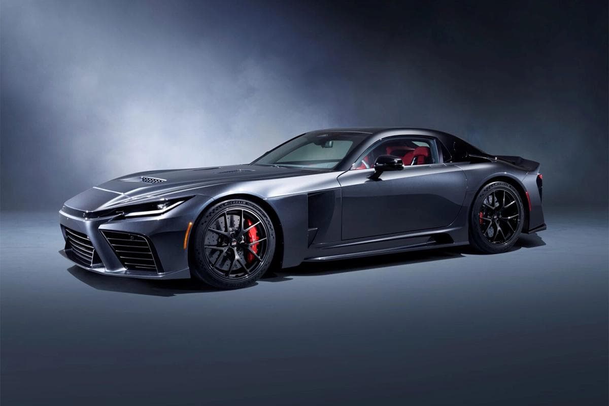 Toyota GR GT road car in a studio setting, shown in a front three quarter view with dark grey paint and red brake calipers.