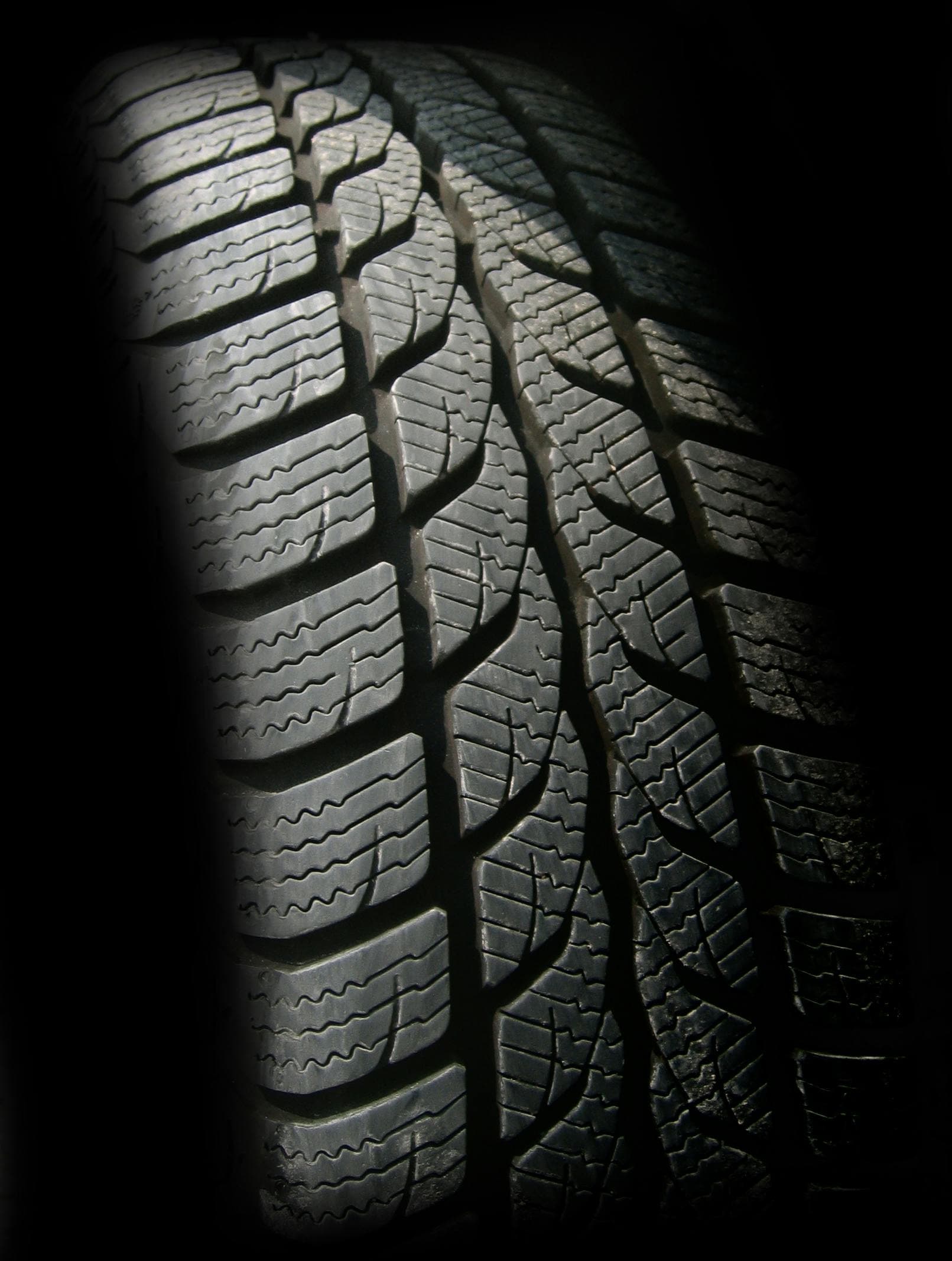 Detailed view of all-season tyre tread pattern showing grooves and sipes for improved traction