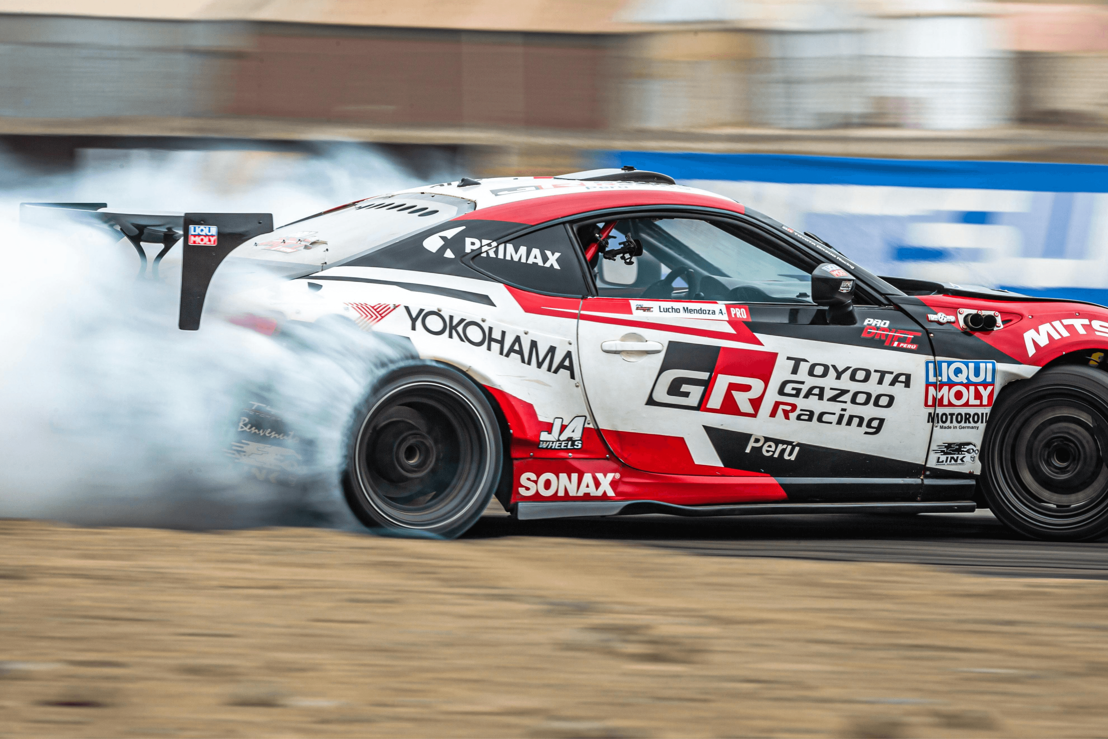 Toyota GT86 drift car from Toyota Gazoo Racing Peru creating tyre smoke during a high-speed drift event