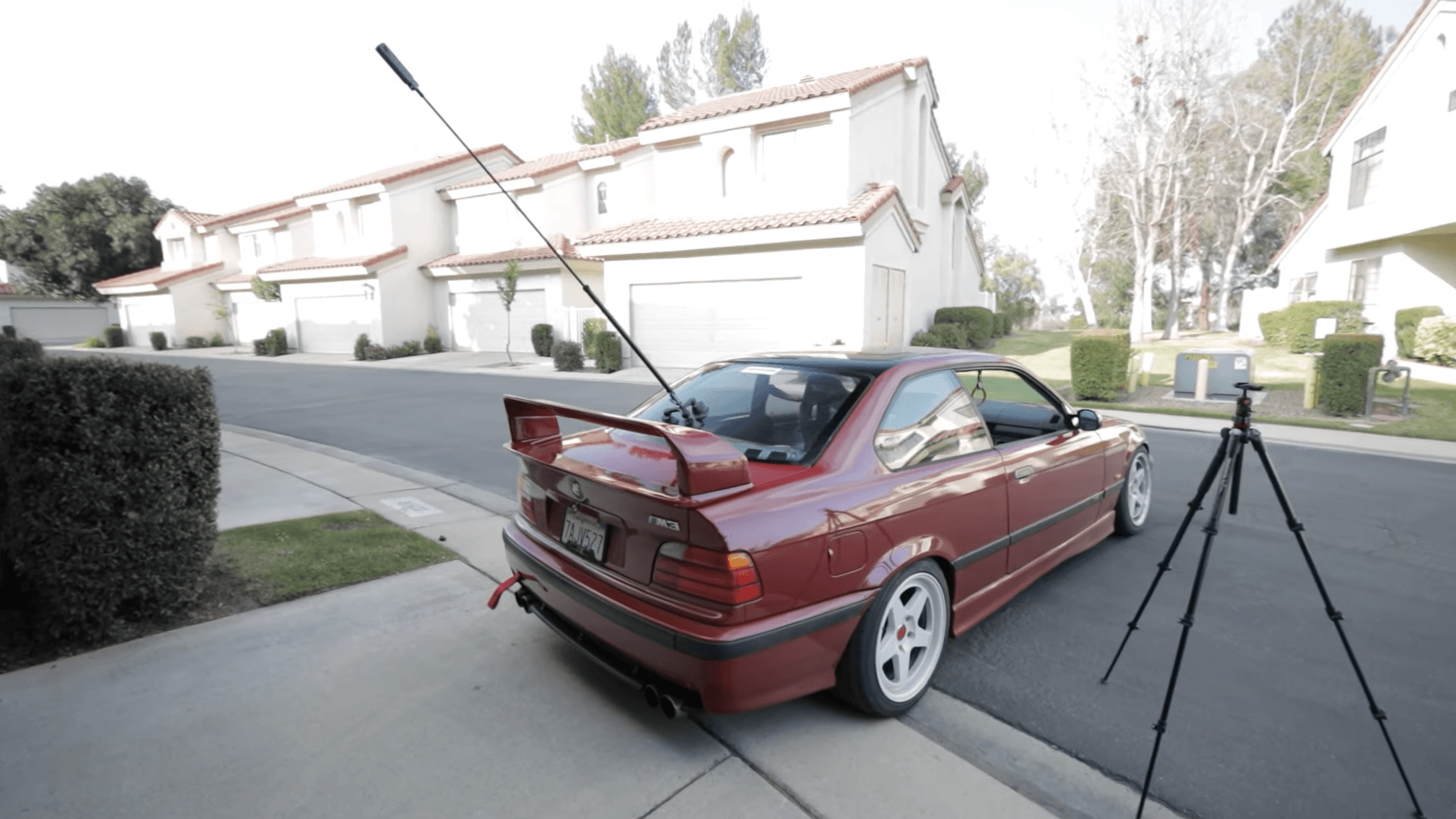 Insta360 X3 camera mounted on a BMW E36 M3 parked in suburban driveway