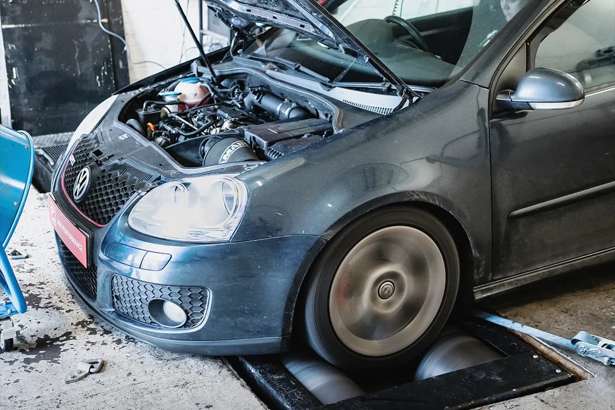 Volkswagen Golf GTi Mk5 on a wheel dyno during a power run with the front wheels spinning on the rollers.